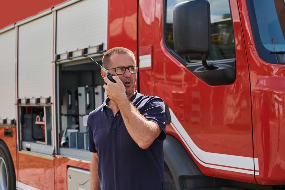 Fire captain communicating with his team in an emergency